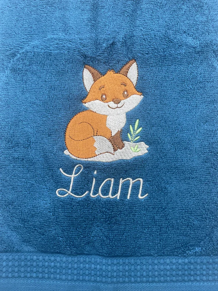 Personalized blue towel with cute embroidered fox and the name Liam in white script